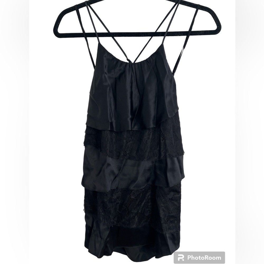 Black cami style top with layers of black lace and silky material.
